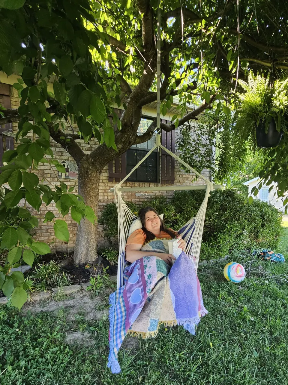 Jordan Williams, the artist behind JAW Creations, relaxing in a garden hammock