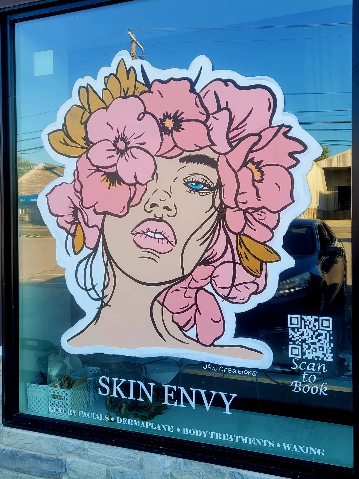 Jordan’s pink floral portrait painted on the Skin Envy storefront window